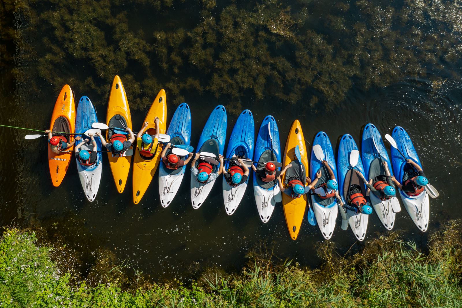 aerial pictures of colourful kayaks in the water